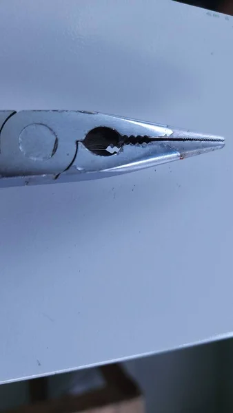 sharp pliers with yellow and green handles for carpentry tools