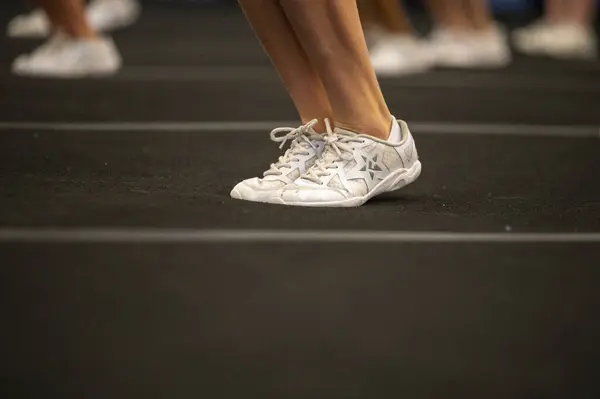 The shoes of young people attending an aerobic exercise class.