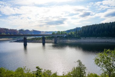 Oker reservoir near Altenau in the Harz Mountains. View from the Okertalsperre to the Oker See and the surrounding landscape. Idyllic nature by the water.