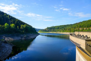 Oker reservoir near Altenau in the Harz Mountains. View from the Okertalsperre to the Oker See and the surrounding landscape. Idyllic nature by the water.