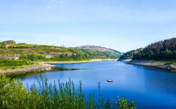 Oker reservoir near Altenau in the Harz Mountains. View from the Okertalsperre to the Oker See and the surrounding landscape. Idyllic nature by the water.