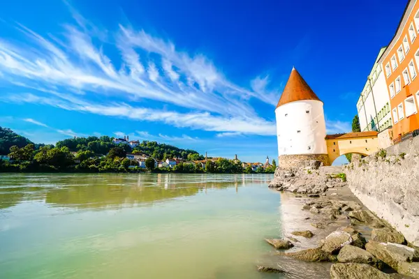 View of the Inn River and the Schaiblingsturm in Passau. Historic round tower of the city with the surrounding landscape. Old defense tower.
