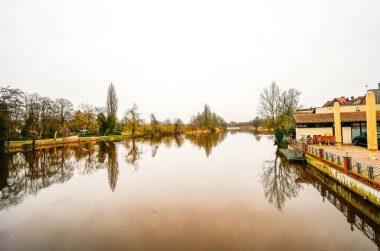 View of the Aller River and the surrounding landscape in Celle. Nature at the Pfennig Bridge. clipart