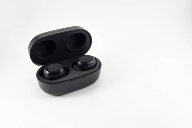 Wireless earphone bluetooth voice control with charger isolated on white background. Wireless earphones with its case opened.