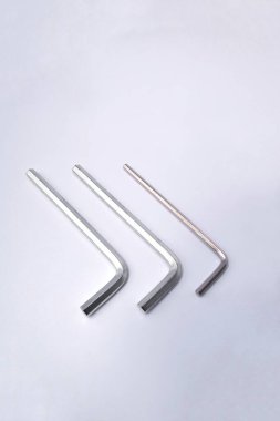 Hex metal allen L key over isolated white background. various sizes