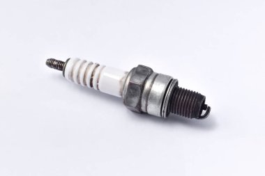 Used motorcycle spark plug isolated on white background.