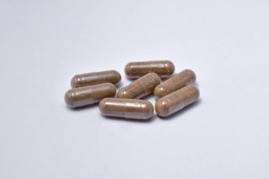 Black Seed with a mixture of propolis in a capsule. isolated white background. (Habbatusauda)