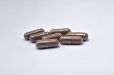 Black Seed with a mixture of propolis in a capsule. isolated white background. (Habbatusauda)