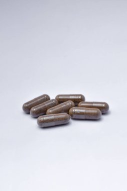 Black Seed with a mixture of propolis in a capsule. isolated white background. (Habbatusauda)