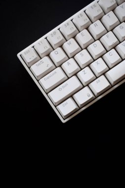 Close up white mechanical keyboard isolated on dark black background
