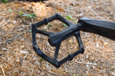 Close and selective focus on road mountain bike pedals.