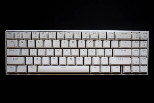 Close up white mechanical keyboard isolated on dark black background