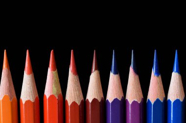 Color pencils isolated on black background. Close up