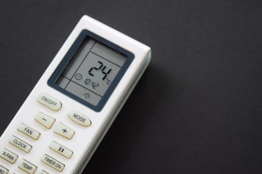 Air conditioner remote on black background. Close up air conditioner 24 degrees celsius