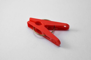 Red plastic clothespin isolated on white background. Plastic clips