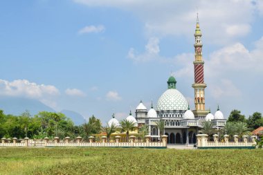 Tiban Mosque, Baujeng, Beji District, Pasuruan, East Java, Indonesia. in the morning with blue sky and white clouds