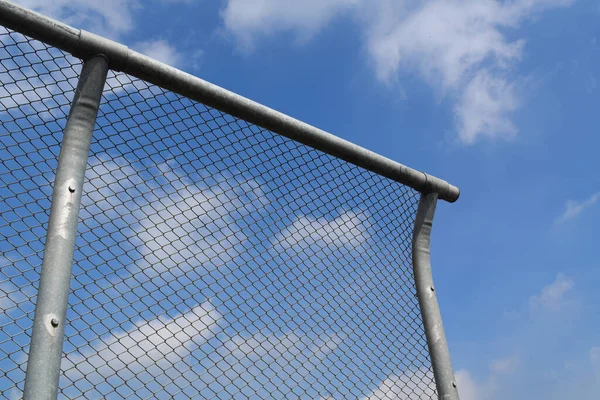 Chain link fence on blue sky. wire fence