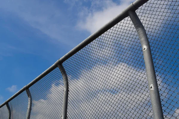 Chain link fence on blue sky. wire fence