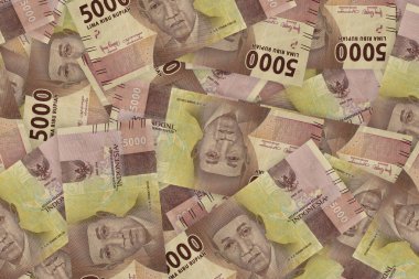 Portrait from Indonesian 5000 Rupiah 2016 Banknotes. Pile of old Indonesian rupiah banknotes series