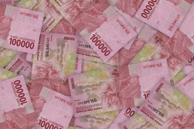Indonesian rupiah banknotes series with the value of one hundred thousand rupiah IDR 100000 issue 2016. One hundred thousand rupiahs. Pile of old Indonesian rupiah banknotes series
