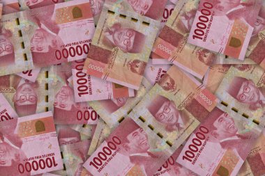 Indonesian rupiah banknotes series with the value of one hundred thousand rupiah IDR 100000 issue 2016. One hundred thousand rupiahs. Pile of old Indonesian rupiah banknotes series