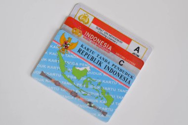 Pasuruan, Indonesia - November 2, 2022 : old SIM A model, new SIM C or Smart SIM (driving license) and KTP (residential card). Isolated on white background