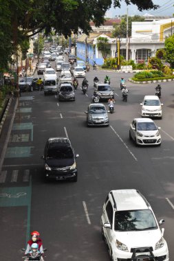 Malang, 07 Desember 2022 - Traffic scene on a highway. Motorcycles and cars. Traffic junctions
