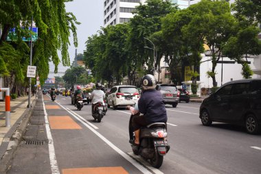 Surabaya, 01 Desember 2022 - Scene of heavy traffic on the highway in Surabaya, East Java. Motorcycles and cars