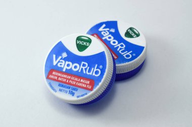 Pasuruan, 03 Desember 2022 - Closeup on bottle of vicks vaporub. It is a medicinal balm for treating small respiratory diseases. Vicks VapoRub ointment is a mentholated topical cream