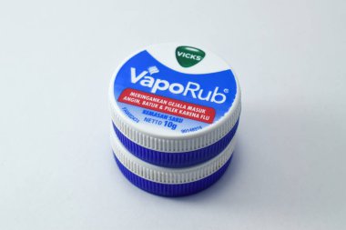 Pasuruan, 03 Desember 2022 - Closeup on bottle of vicks vaporub. It is a medicinal balm for treating small respiratory diseases. Vicks VapoRub ointment is a mentholated topical cream