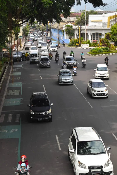 Malang, 07 Desember 2022 - Traffic scene on a highway. Motorcycles and cars. Traffic junctions
