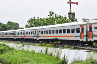 Pasuruan - November 17, 2022 : KAI train that is passing go to Railway Station. With a new logo owned by Indonesian Railways Company (KAI).