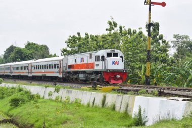 Pasuruan - November 17, 2022 : KAI train that is passing go to Railway Station. With a new logo owned by Indonesian Railways Company (KAI).