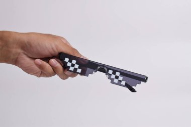 El ele tutuşan Haydut can gözlüğü beyaz arka planda izole edilmiş. Piksel resim gözlükleri