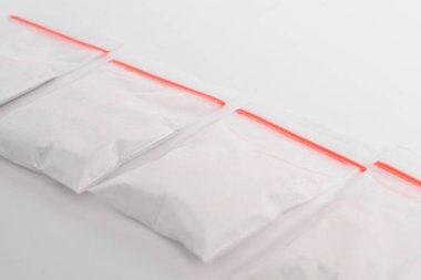 Beyaz arka planda izole edilmiş plastik pakette kokain. Yasadışı uyuşturucu maddeler, beyaz toz, narkotik