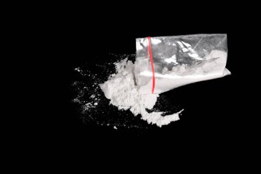 Siyah arkaplana serpiştirilmiş plastik pakette kokain. Yasadışı uyuşturucu maddelerinin ve uyuşturucuların gösterimi
