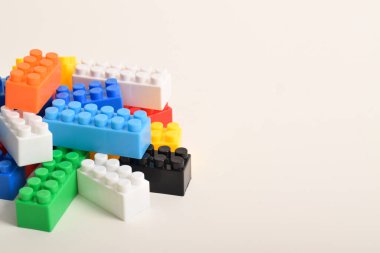 Beyaz arkaplanda izole edilmiş renkli plastik oyuncak blokları yığını