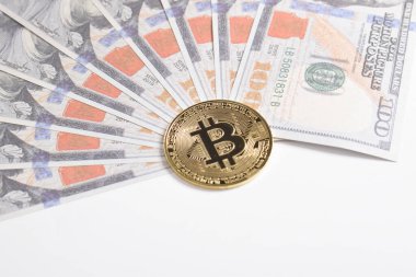 100 dolarlık banknotlarda Bitcoin 'in altın sembolik parası. İzole edilmiş arka plan. Bitcoin 'i bir dolarla takas et. Amerikan dolarları üzerinde kripto para birimi. Tasarruf, yatırım kavramı