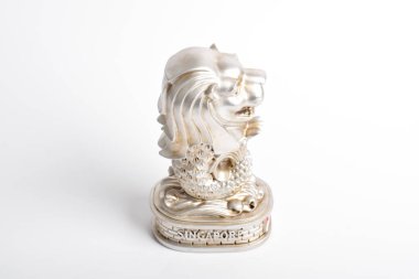 Mini deniz aslanı heykelleri. Beyaz arka planda izole edilmiş altın rengi Singapur Merlion hatırası