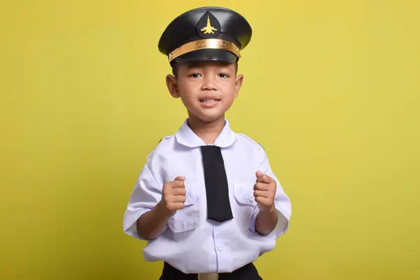 stock image Little Asian boy Airplane pilot isolated on yellow background celebrating a victory. Little boy dreams of becoming an airplane pilot.