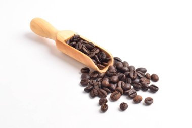 Tahta kaşık beyaz arka plan üzerinde izole içinde kavrulmuş kahve çekirdekleri