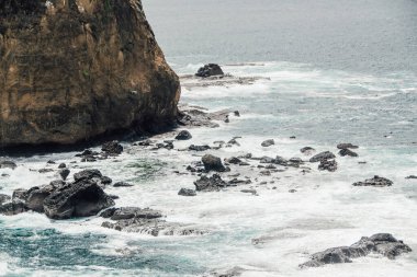 Okyanus dalgaları ve kayalık kayalıklar güzel bir sahilde