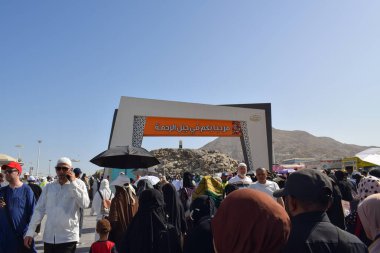 Makkah - 2 Nisan 2025: Arafat, Suudi Arabistan 'daki Arafat Dağı veya Jabal Rahmah Dağı' na bir grup Müslüman gidiyor. Burası Adem ve Havva 'nın cennetten düştükten sonra buluştukları yer..