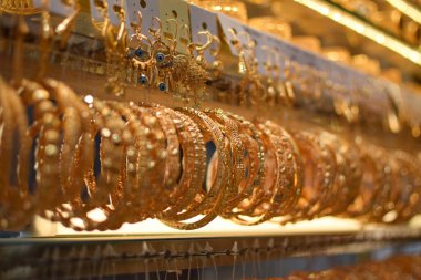 Bir kuyumcuda çeşitli lüks altın bilezikler sergileniyor.