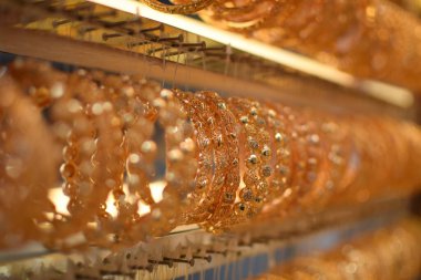 Bir kuyumcuda çeşitli lüks altın bilezikler sergileniyor.