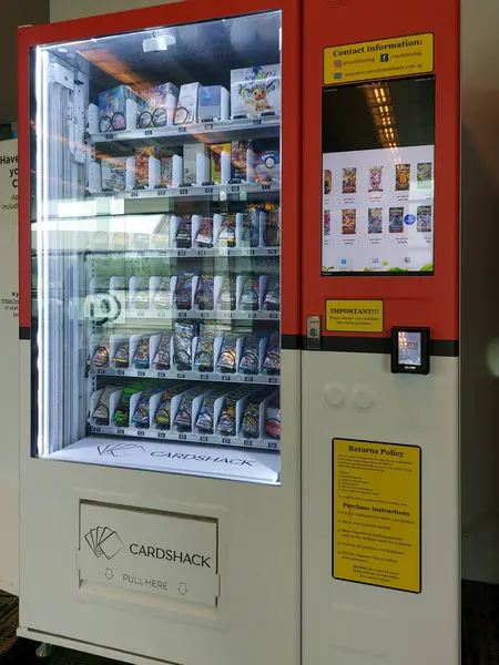 Singapur - 25 Şubat 2025: Pokemon oyuncak kartı otomatı Changi Havaalanı, Singapur. Nakit veya kredi kartı ödeme seçenekleri içeren sarı makine
