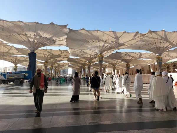 Al-Madinah al-Munawwarah, Suudi Arabistan - 1 Mart 2025: Açık mavi gökyüzü altında açık şemsiyeler ve minarelerle Medine 'deki Peygamber Camii.