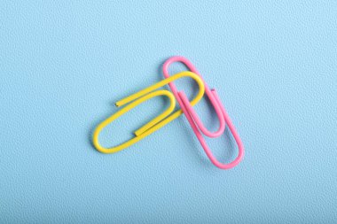 Açık mavi arkaplanda iki ataç izole edildi