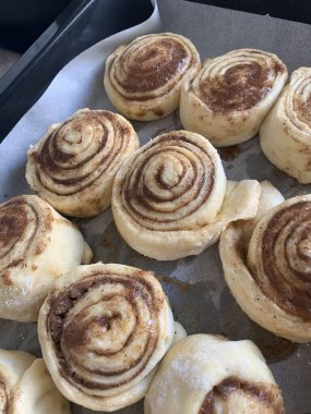 homemade Cinnabons in oven. delicious pastries.