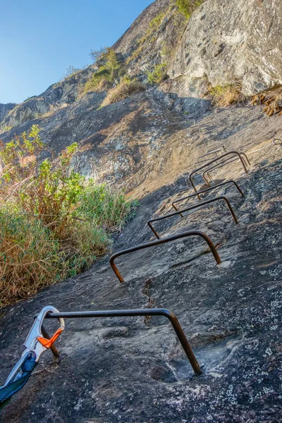 Stock image Iron Bars Ladder Bolted in Vertical Rock for Climbing.